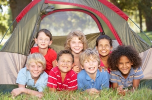 Group Of Children Having Fun In Tent In Countryside